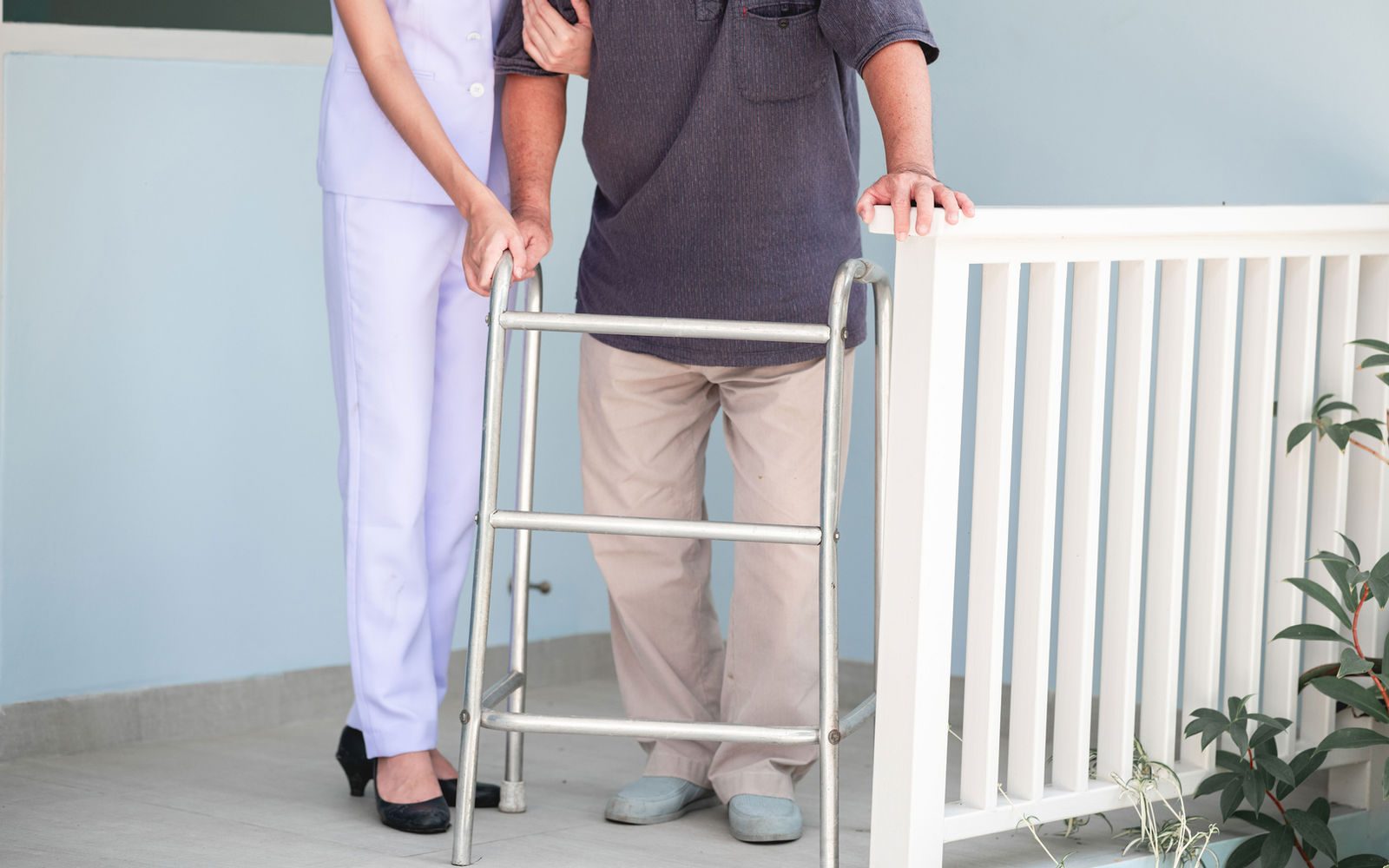 Senior man walking with support at home